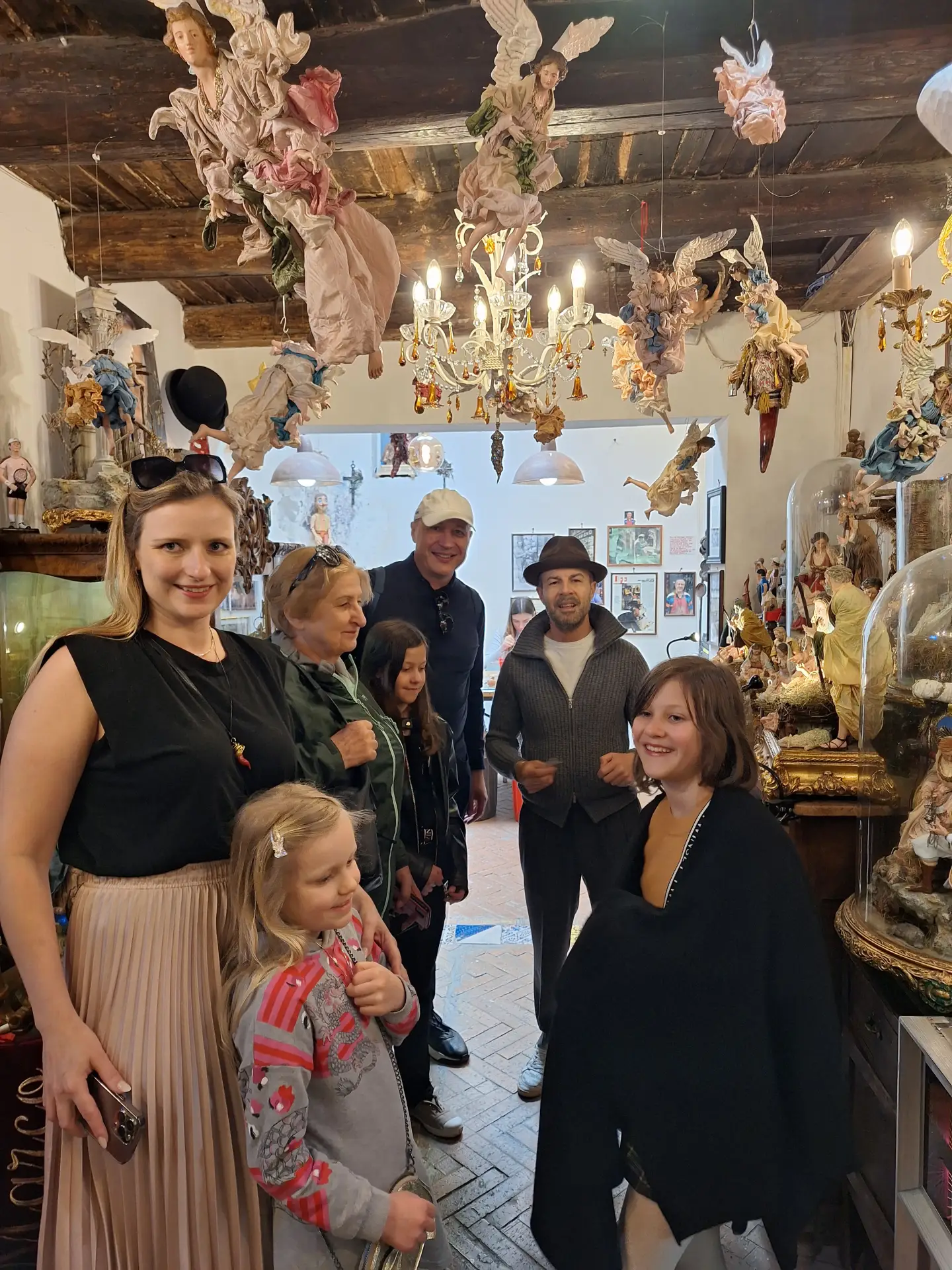 Tourists exploring the intricate interiors of the Ospedale delle Bambole in Naples