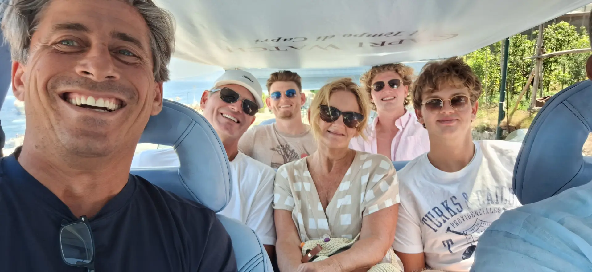 Golf cart with smiling tourists exploring CapriGolf cart tour in Capri