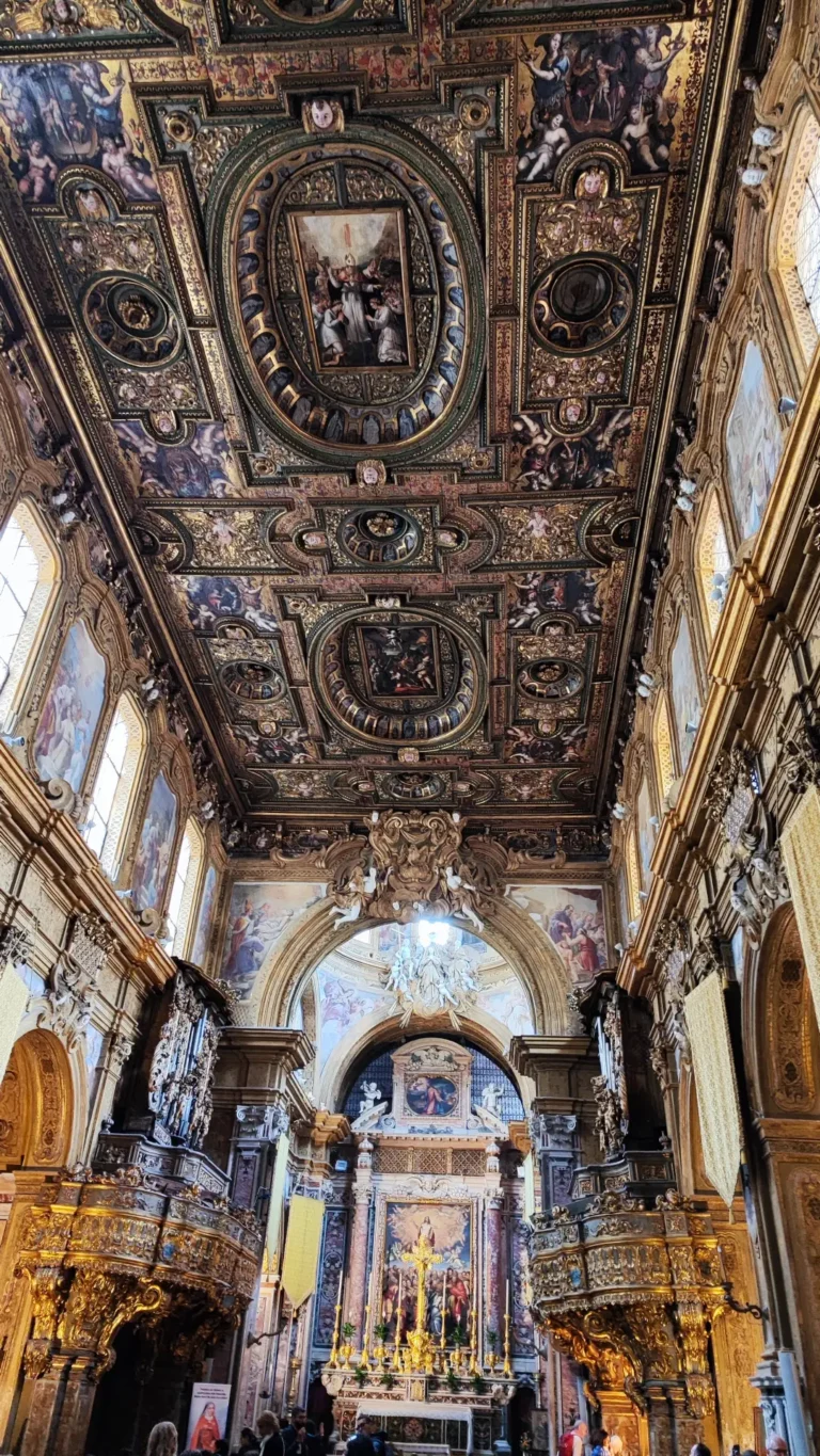 Interior of a church in Naples with a frescoed ceiling and golden details