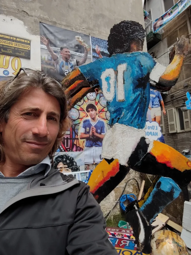 Luca next to a mural dedicated to Diego Armando Maradona in Naples