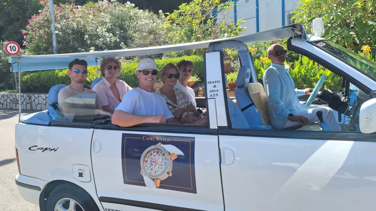 Family tourist group of five persons, sitting in a private Capri taxy, with the driver waiting for Luca.