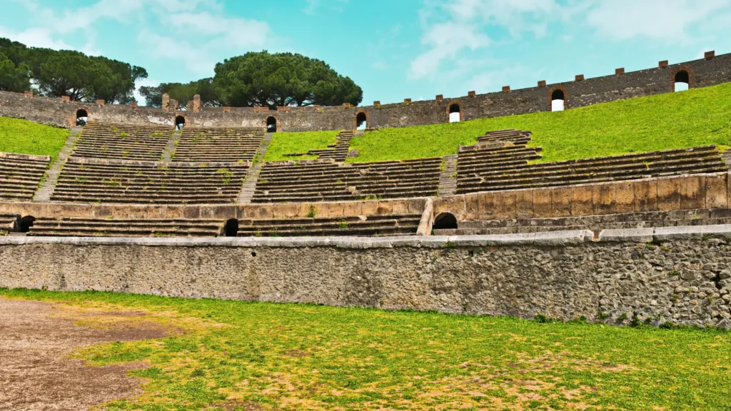 The Amphitheater of Pompeii, an ancient Roman arena with stone seating and an elliptical arena floor