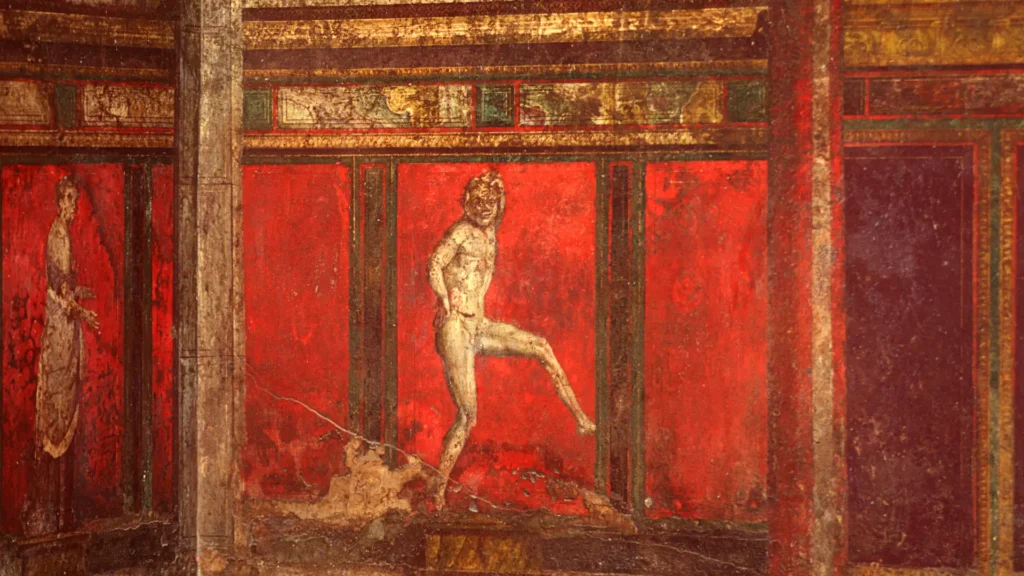 A red fresco in the Villa of the Mysteries in Pompeii, depicting a Dionysian initiation scene