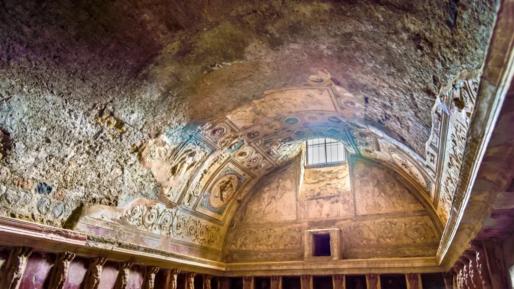 The Stabian Baths in Pompeii, featuring well-preserved Roman thermal bath structures with columns and open courtyards