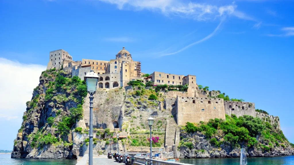 Panoramic view of Sant'Angelo, Ischia, showcasing the castle, the island, and the pier in the background