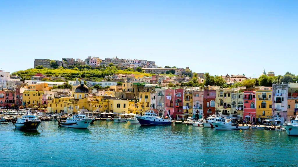 The colorful landscape of Procida Island, with its vibrant houses, fishing boats, and scenic coastline