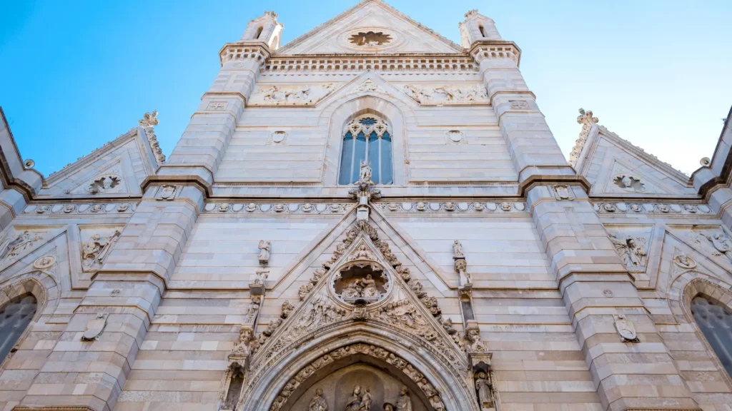 Low-angle view of Naples Cathedral, showcasing the grandeur of the cathedral and the sky in the background