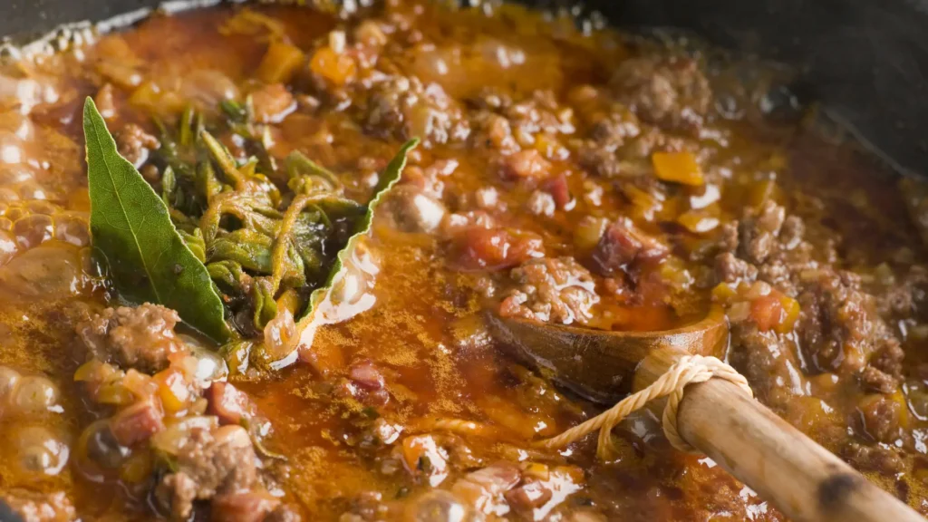 Close-up of Neapolitan Genovese sauce, a slow-cooked onion and meat ragù simmering in a pot